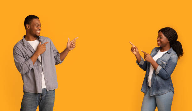 istock Look There. Joyful black couple pointing at copy space between them 1328834427