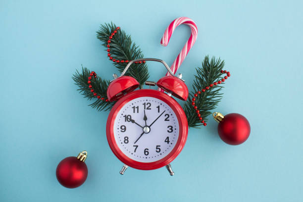 istock Red alarm clock and Christmas composition on the blue background. Top view. Copy space. 1328834982