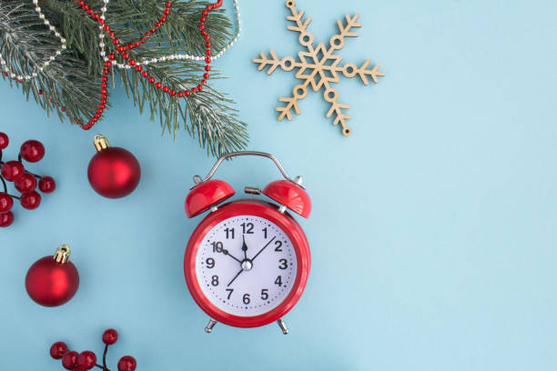 istock Christmas composition with  red alarm clock on the blue background 1328835052