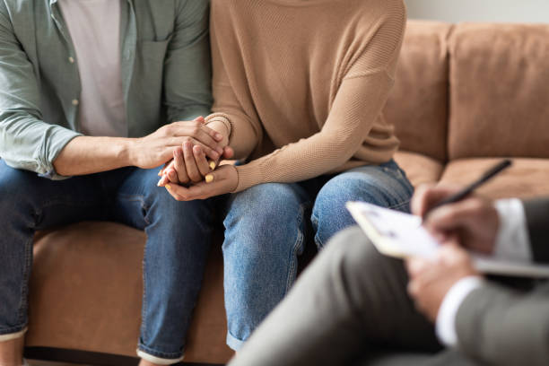 istock Couple talking at session with male therapist 1328835220