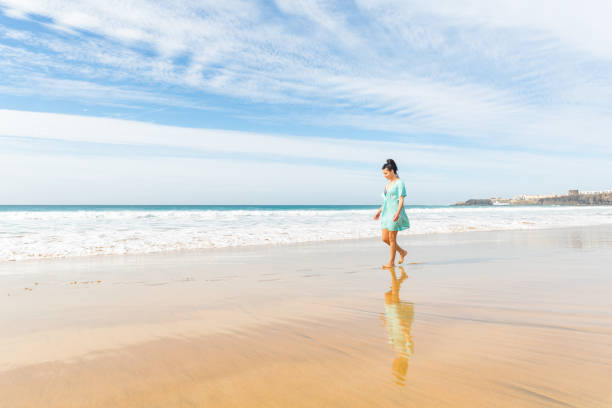 istock Happy young woman having fun at seaside 1328835377
