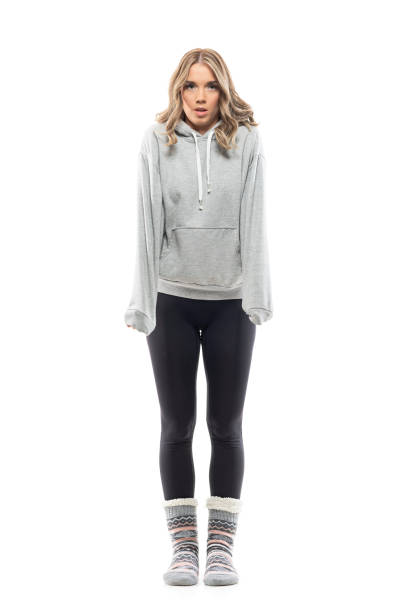 istock Trembling and shivering young woman in sweatshirt feeling cold warming hands with sleeves 1328836391