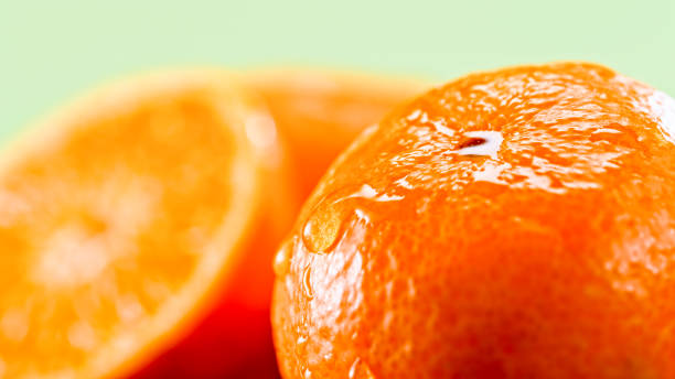 istock Water droplets gliding down a tangerine 1328837919