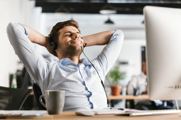 istock Cheerful office manager talking by headset with microphone 1328838944