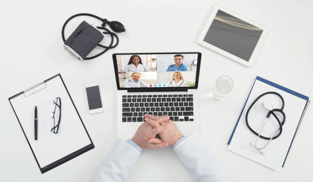 istock Unrecognizable Doctor Making Video Call Consulting With Diverse Colleagues, Top-View 1328839805