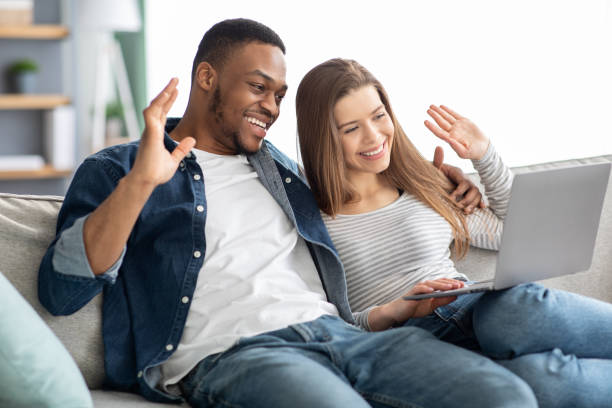 istock Video Call. Cheerful Young Multicultural Couple Having Web Conference On Laptop 1328840130