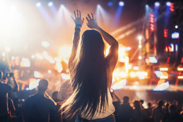 istock Woman enjoying a concert party 1328840198