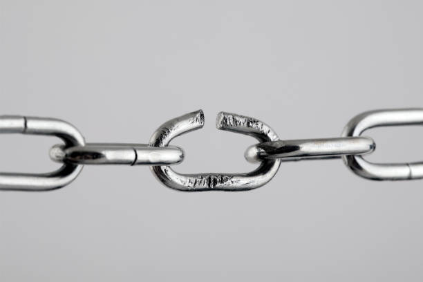 Broken silver metal chain, concept of freedom. stock photo