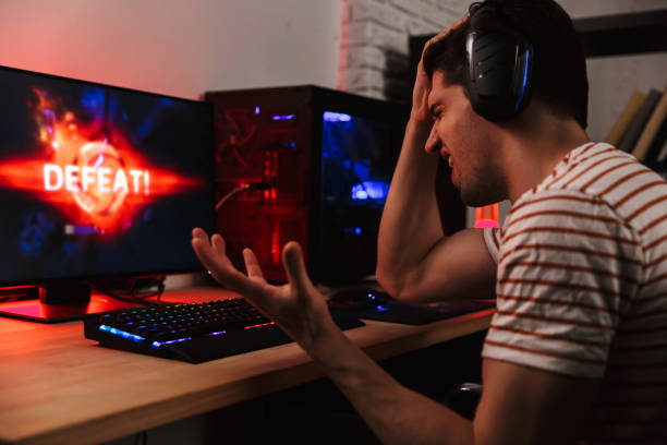 istock Side view of confused gamer playing video games on computer 1328840588