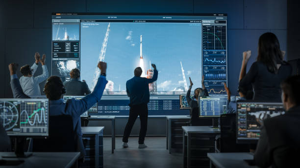 Group of People in Mission Control Center Witness Space Rocket Launch. Flight Director is Pacing Nervously in Front of the Screen. Group of People in Mission Control Center Witness Space Rocket Launch. Flight Director is Pacing Nervously in Front of the Screen. cosmonaut photos stock pictures, royalty-free photos & images
