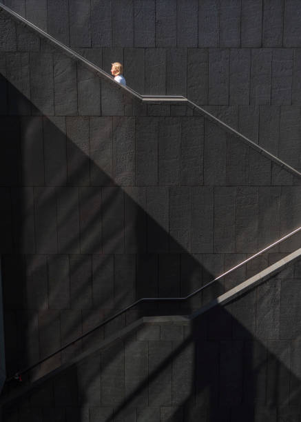 Woman climbing a ladder stock photo