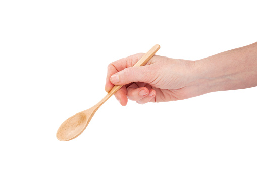 Woman hand hold a wood spoon