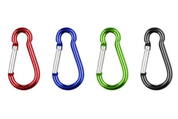 A set of carabiners isolated on a white background - red, green, black color. Close-up studio photo.