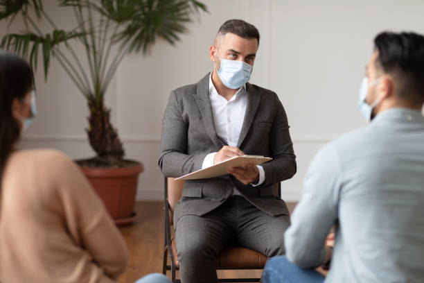 istock Couple talking at therapy session with male therapist 1328843732