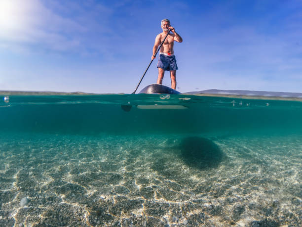 istock Mature man enjoying paddleboarding 1328845188