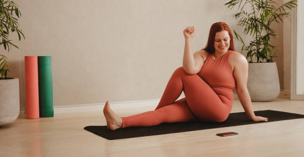 istock Woman following instruction on cellphone while doing yoga 1328846690