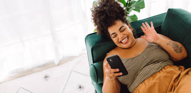 istock Woman having video call with her cell phone 1328846948