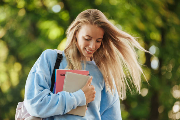 istock Close up of smiling young girl student with backpack 1328848315