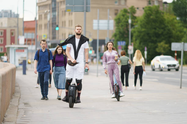 people driving electric unicycles - unicycle men young adult standing imagens e fotografias de stock