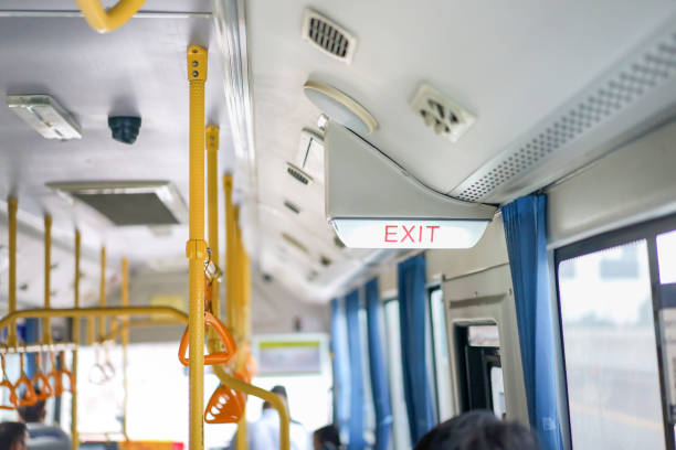 istock Exit sign light box is hung on the ceiling inside the bus, Thailand. 1328854985