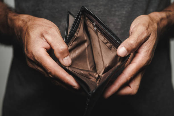 Close up of man hands holding and empty wallet. financial crisis, bankruptcy, no money, bad economy Concept. Close up of man hands holding and empty wallet. financial crisis, bankruptcy, no money, bad economy Concept. poverty stock pictures, royalty-free photos & images