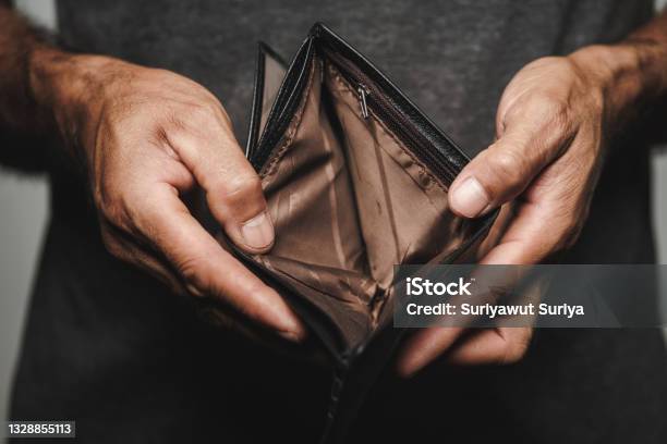 Close Up Of Man Hands Holding And Empty Wallet Financial Crisis Bankruptcy No Money Bad Economy Concept Stock Photo - Download Image Now