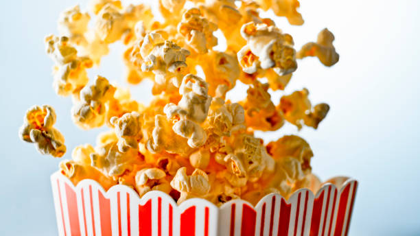 istock Popcorn overflowing from red striped carton 1328855589