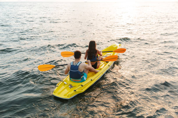 istock Rear view of beautiful young couple kayaking 1328856693