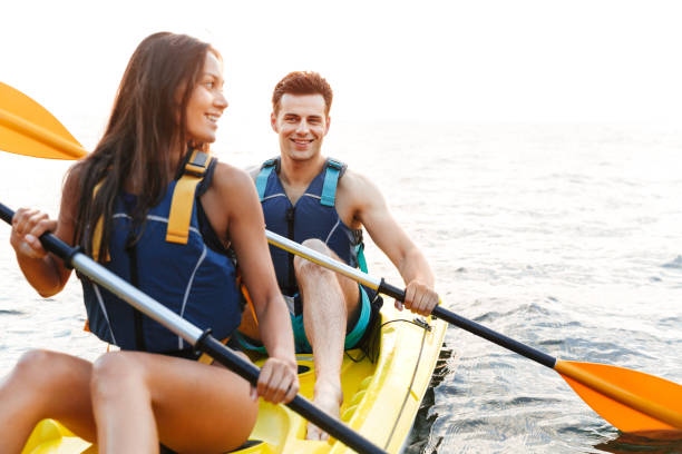 istock Cheerful young couple kayaking 1328856917