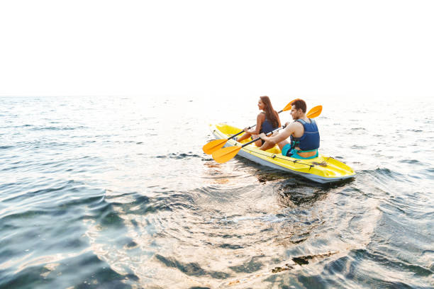 istock Attractive young couple kayaking on lake 1328857537