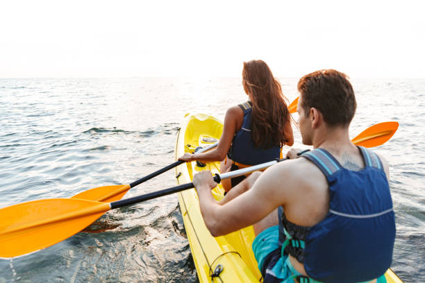 istock Back view of couple kayaking 1328857595