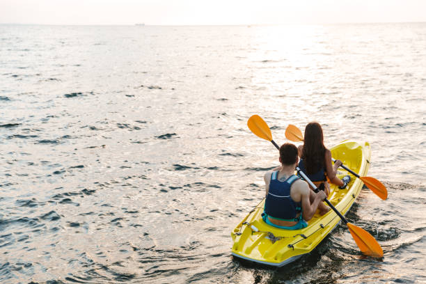 istock Back view of an attractive young couple kayaking 1328857639