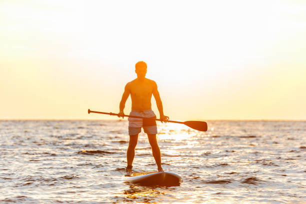 istock Handsome man kayaking on lake sea. 1328857756