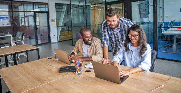 istock Employee discussing statement with experienced staff in conference room 1328859061