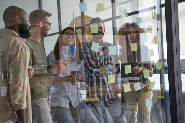 istock Staff relaxing and discussing agreements together in office 1328859103