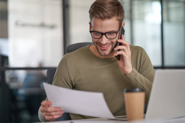 istock Man talking on phone in cozy cabinet 1328859127