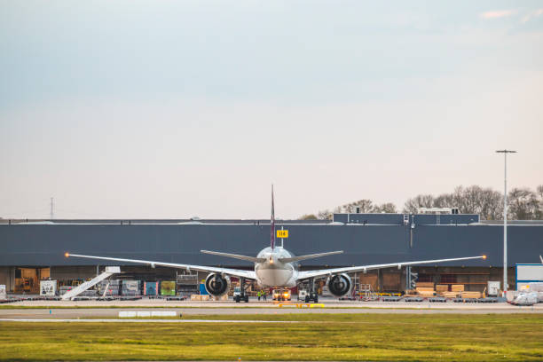 Loading a cargo plane A cargo plane landed at an airport that gets loaded. liege belgium stock pictures, royalty-free photos & images