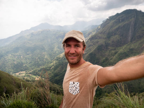 istock Man takes selfie photo on mountain top 1328859973