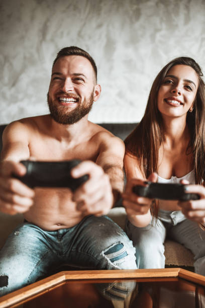 istock Smiling Couple Enjoying Video Game Time Together 1328860746