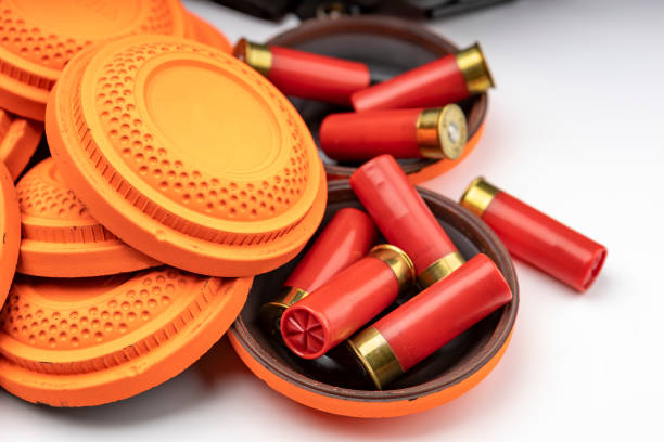 istock Shotgun bullets and Clay disc flying target on white background 1328862838