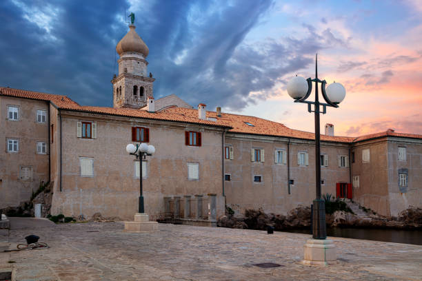 Cityscape image of Krk, Croatia located on Krk Island with the  Krk Cathedral at summer sunset.