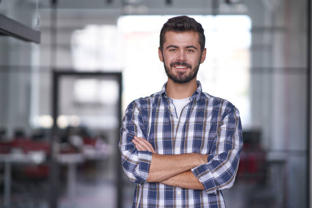 istock Handsome man with folded hands in conference room 1328865843