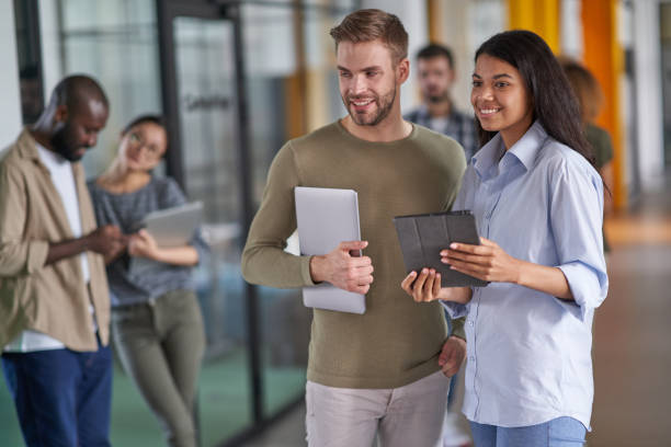 istock Woman and man holding electronic gadgets and waiting 1328865853