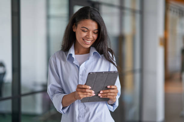 istock Happy woman working with modern gadget in office 1328865858