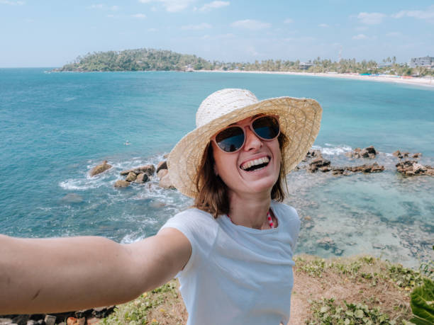 istock Woman takes selfie with seascape 1328866020