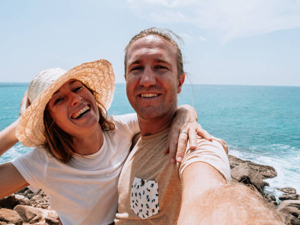 istock Couple take selfie by the coastline 1328866052