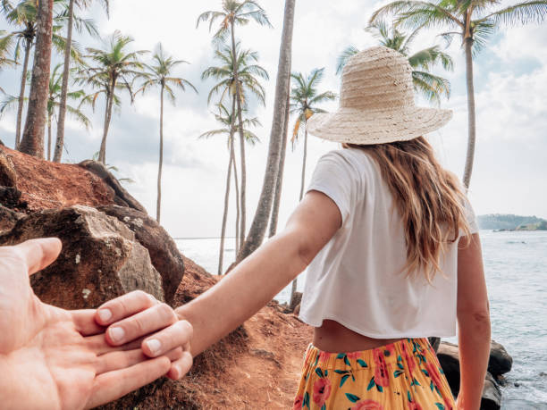 istock Couple holding hands on mountain palm tree hill 1328866201