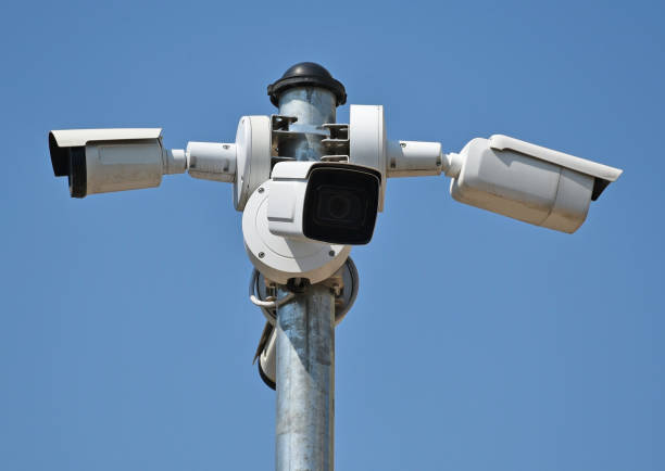 istock Security cameras on a metal pole against sky 1328868416