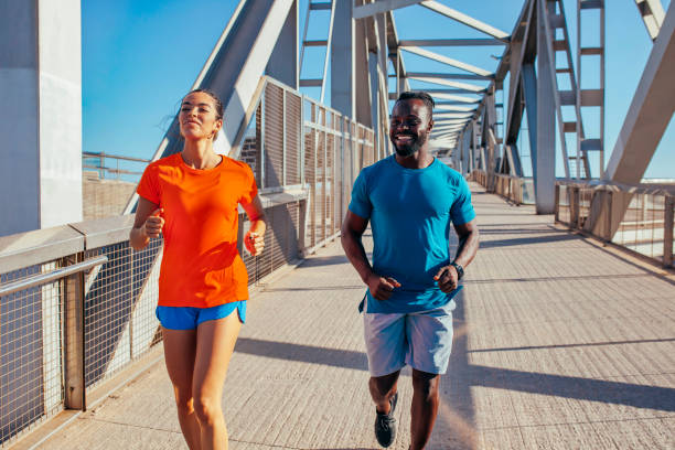 istock Running couple jogging outside in city 1328870805