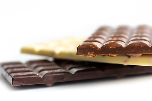A whole and half chocolate bar on a white background. Chocolate bars with filling.